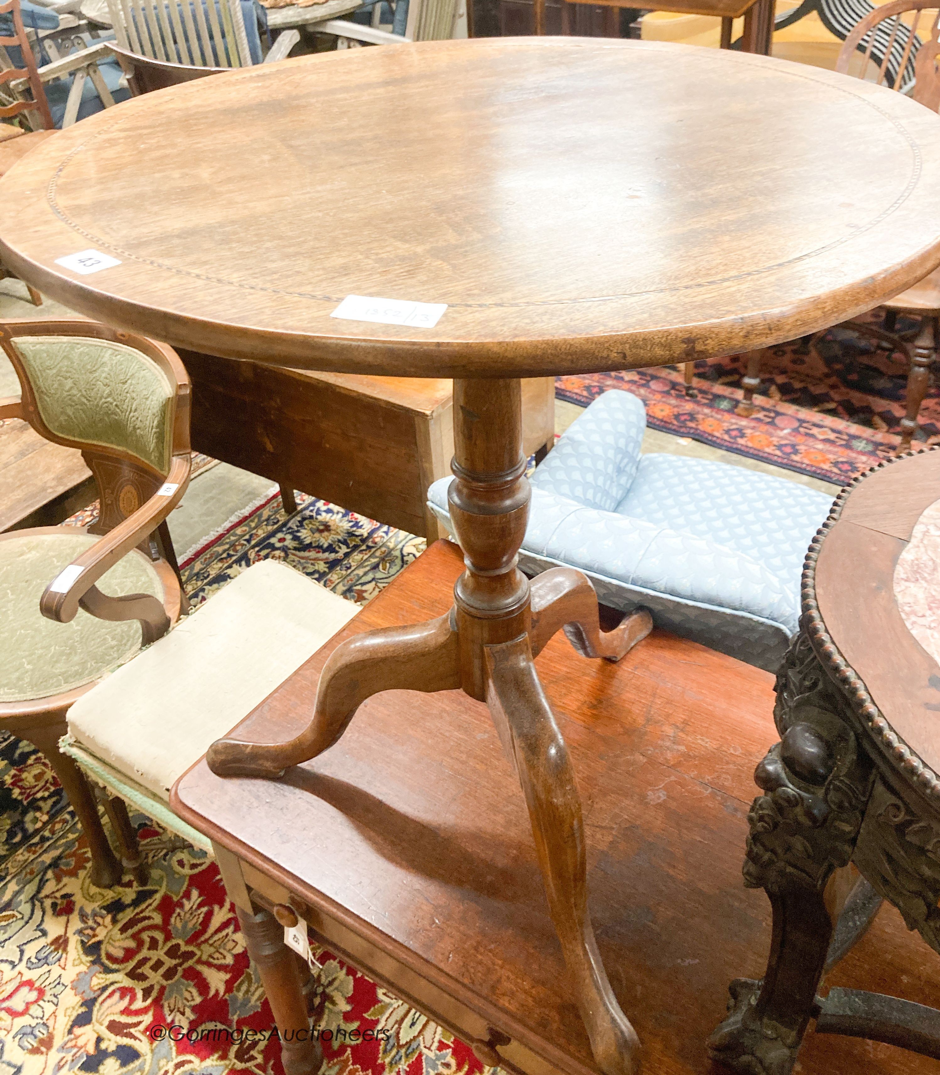 A George III circular mahogany tilt top tea table, diameter 65cm, height 70cm